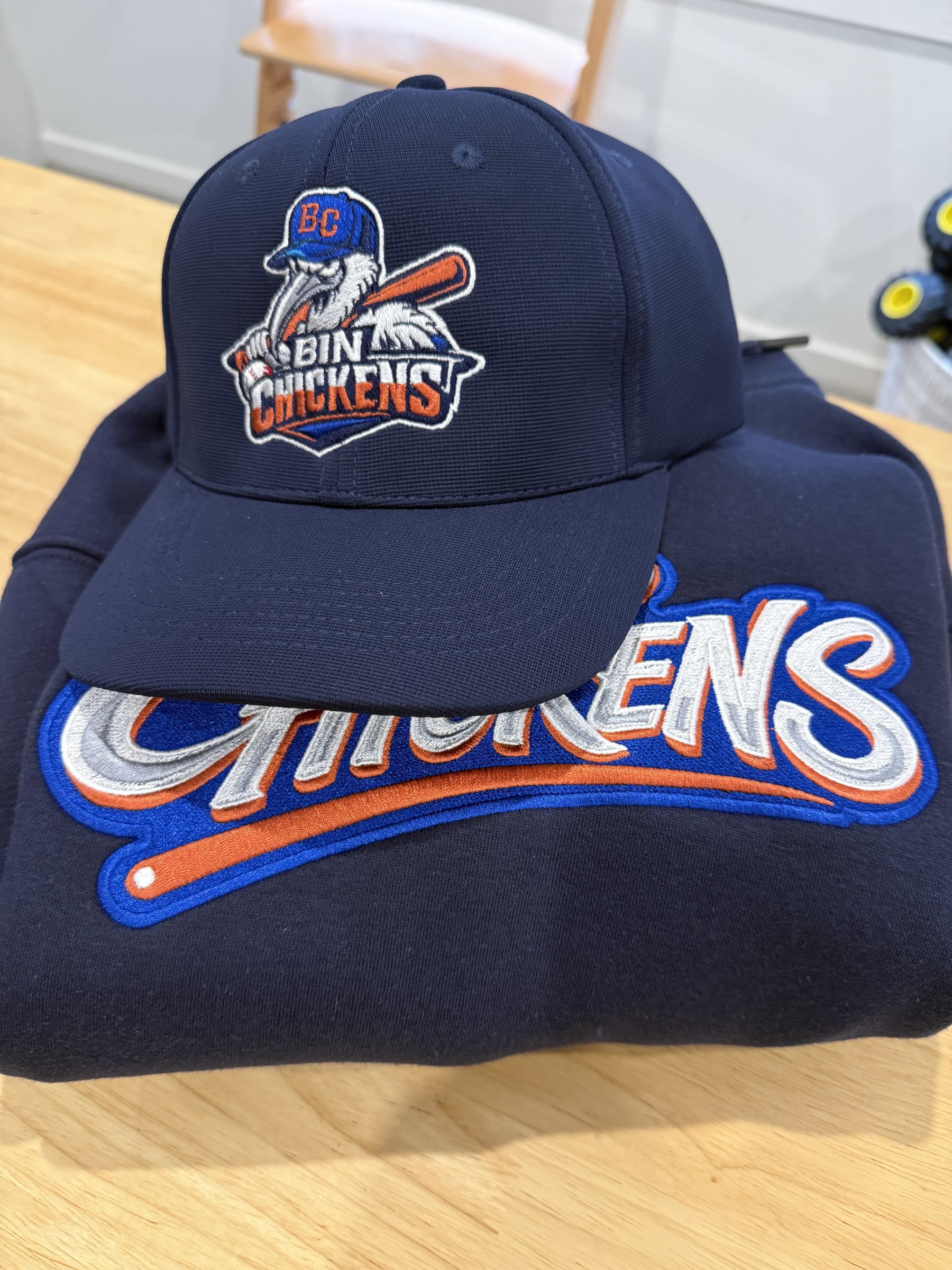 Custom cap and hoodie merchandise.